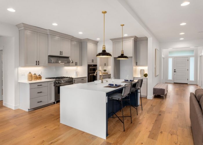 Kitchen with gold accented pendant lighting and recessed lights